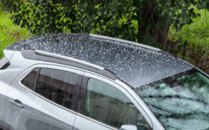 Vehicle with hail dents inspected for paintless dent repair in Calgary